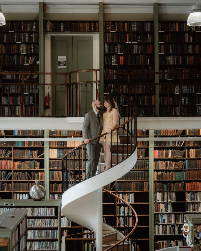 Couples wedding portraits at The Leeds Library Wedding Venue on the spiral staircase